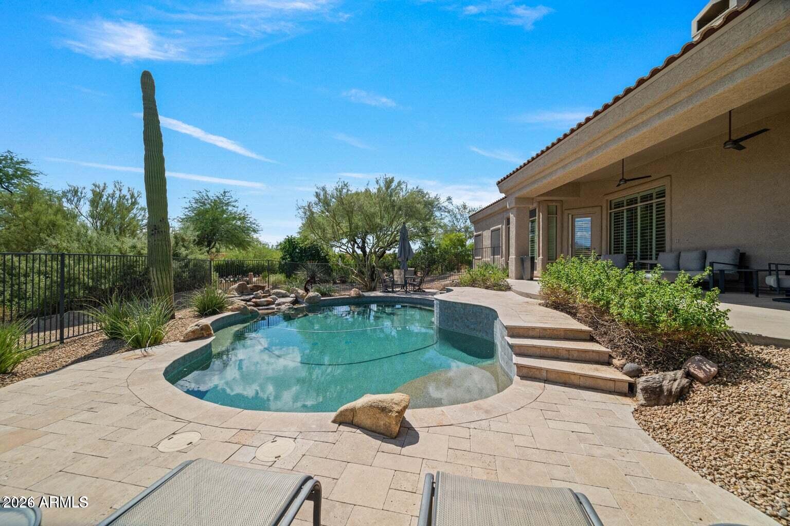 26601 North Aguila Road Rio Verde, AZ 85263 - Photo 42 of 45 a view of a swimming pool with a patio