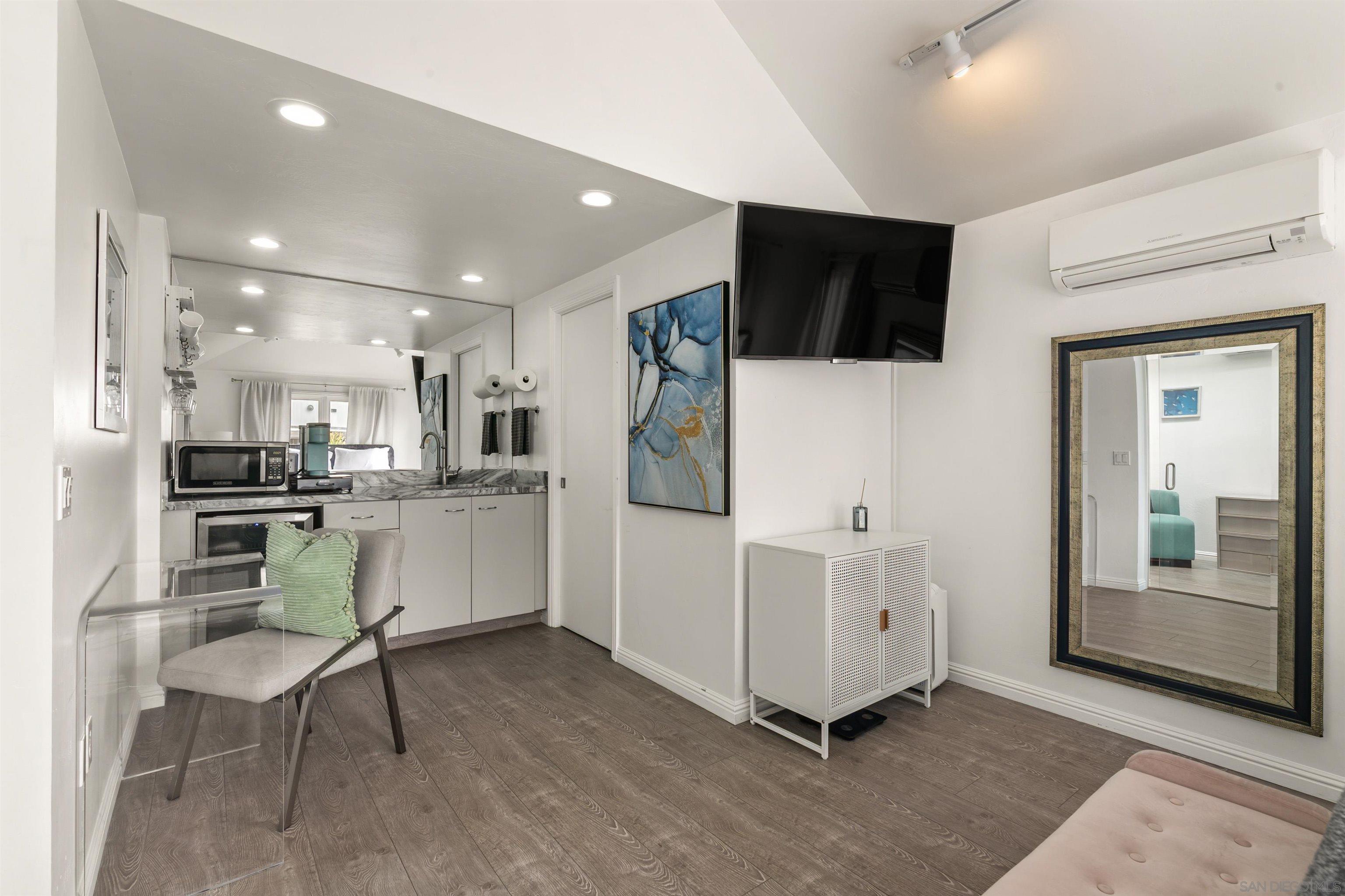 1264 Prospect Street La Jolla, CA 92037 - Photo 4 of 10 a kitchen with white cabinets and stainless steel appliances