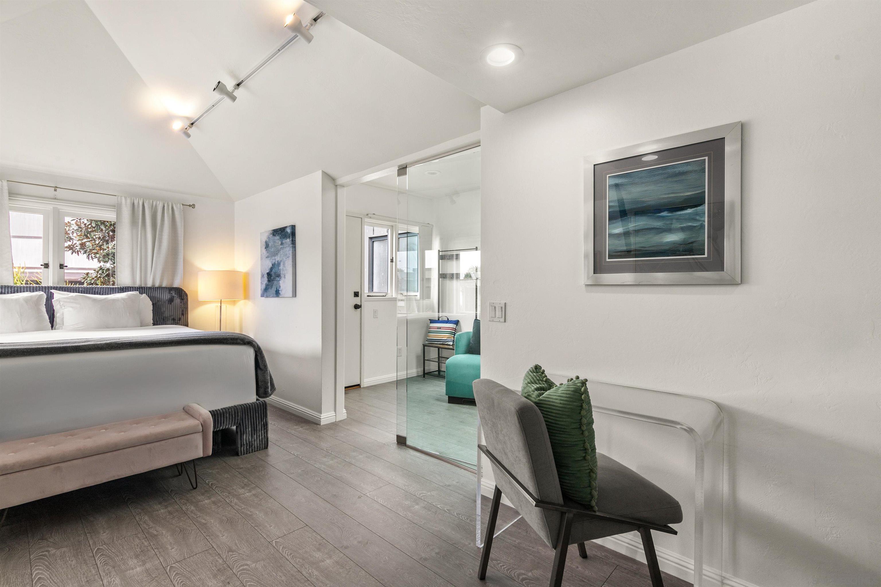 1264 Prospect Street La Jolla, CA 92037 - Photo 7 of 10 a bedroom with a bed and furniture