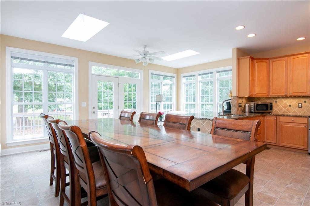 8412 Chartwell Drive Oak Ridge, NC 27310 - Photo 11 of 30 Enough room for a large table plus the natural light makes it sunny and bright