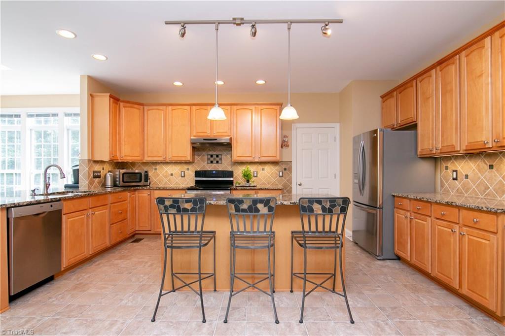 8412 Chartwell Drive Oak Ridge, NC 27310 - Photo 7 of 30 Look at all the prep space on these gorgeous granite counters and large center island