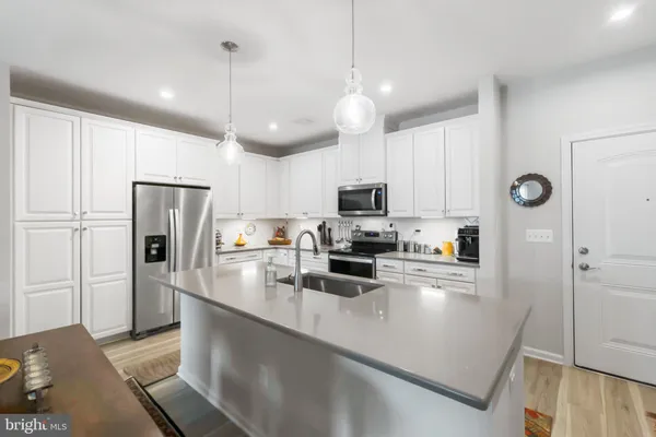 a kitchen with refrigerator cabinets and microwave
