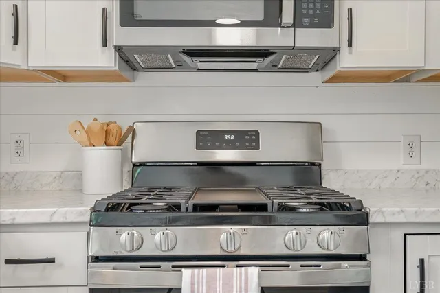 a stove top oven sitting inside of a kitchen
