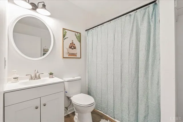 a bathroom with a toilet a sink and a mirror