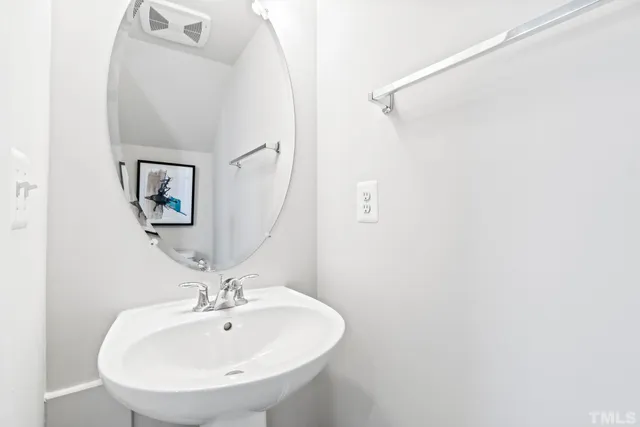 a bathroom with a sink double vanity and a mirror