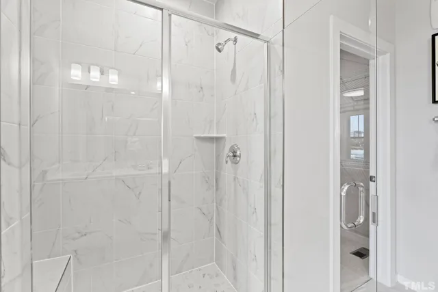 a bathroom with a granite countertop sink a mirror and shower