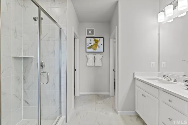 a bathroom with a double vanity sink and a mirror