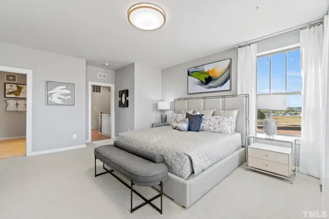 a bedroom with a bed and a television