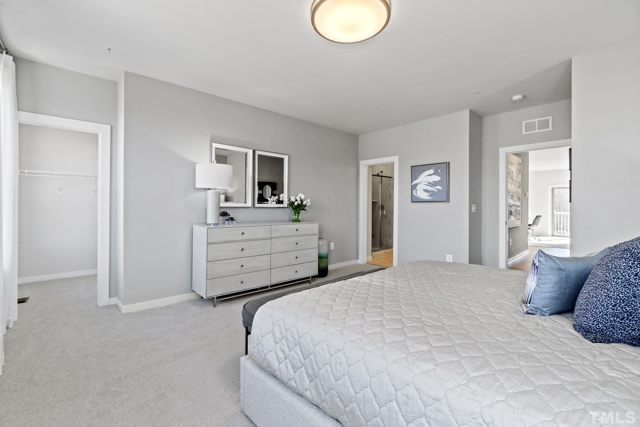 415 Wait Avenue, Unit 100 TESSA Wake Forest, NC 27587 - Photo 19 of 29 a bedroom with a bed and a television