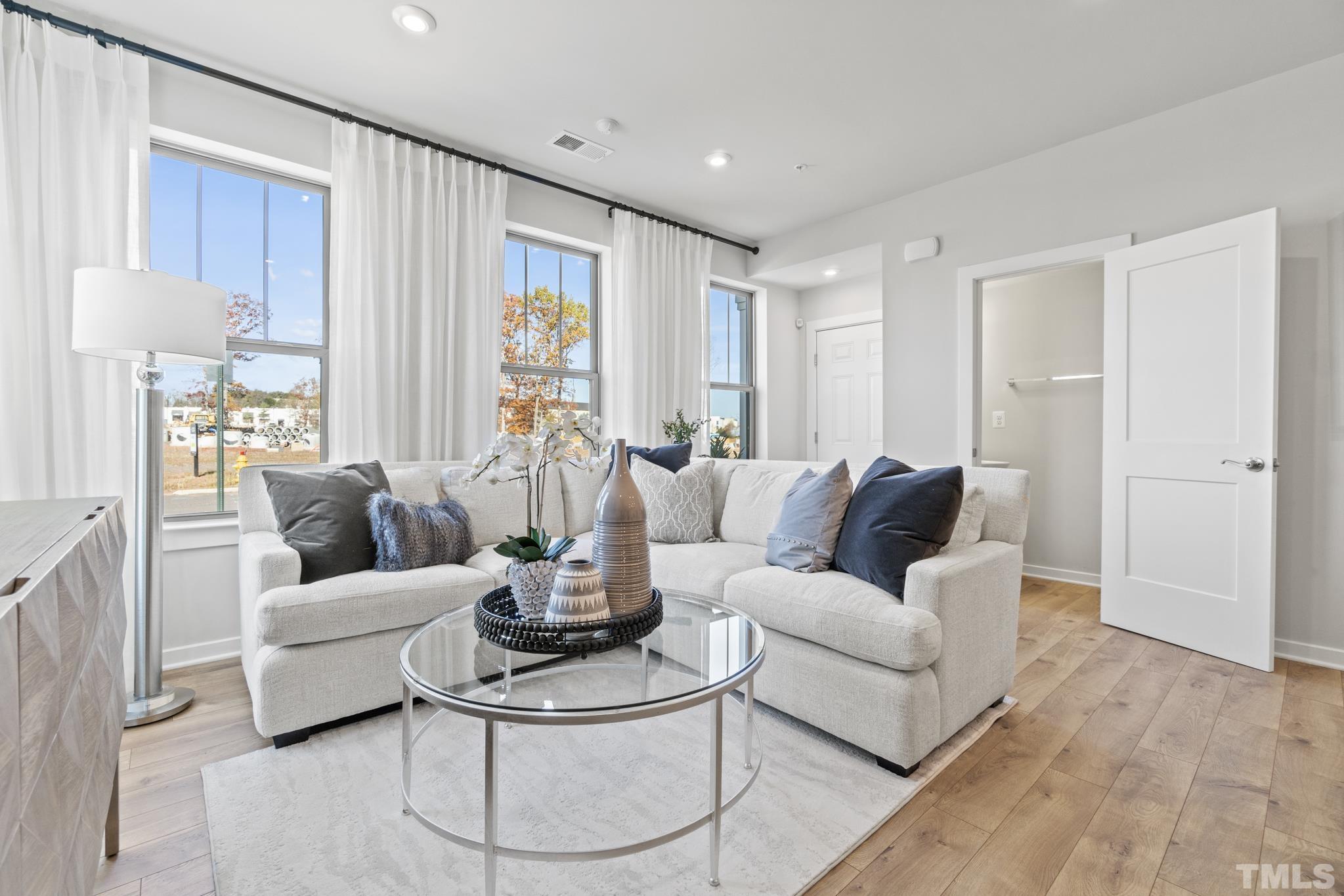 415 Wait Avenue, Unit 100 TESSA Wake Forest, NC 27587 - Photo 7 of 29 a living room with furniture and a large window