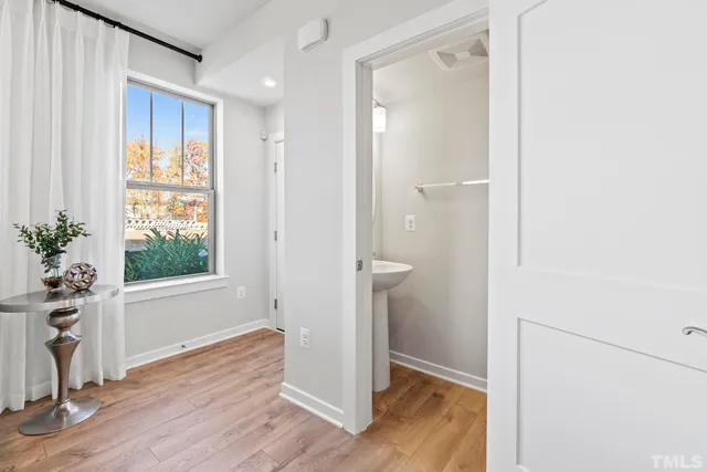 a kitchen with a sink cabinets and wooden floor
