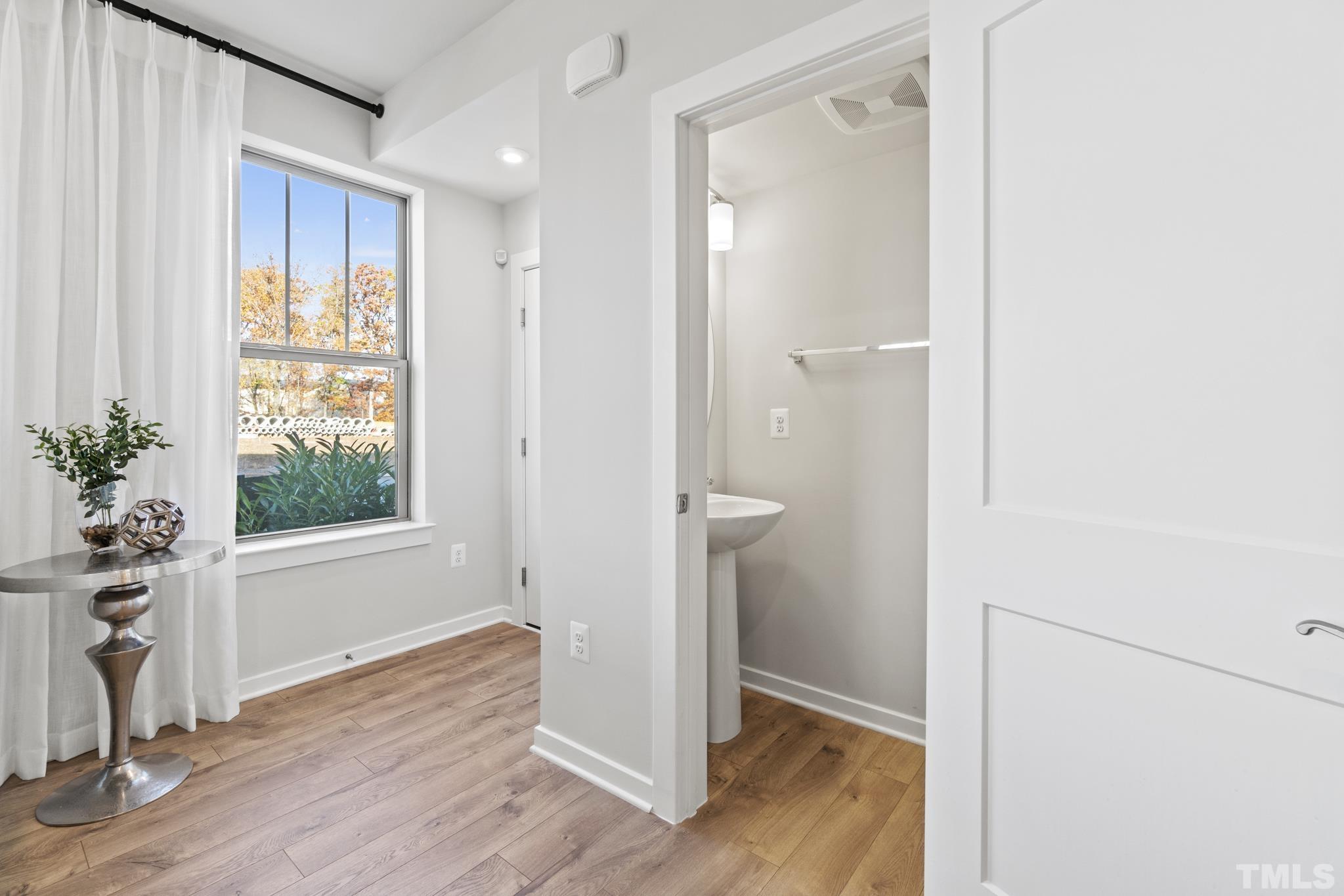 415 Wait Avenue, Unit 100 TESSA Wake Forest, NC 27587 - Photo 9 of 29 a view of empty room with wooden floor and fan