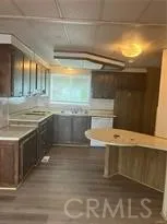 a view of kitchen with stainless steel appliances cabinets and outdoor space