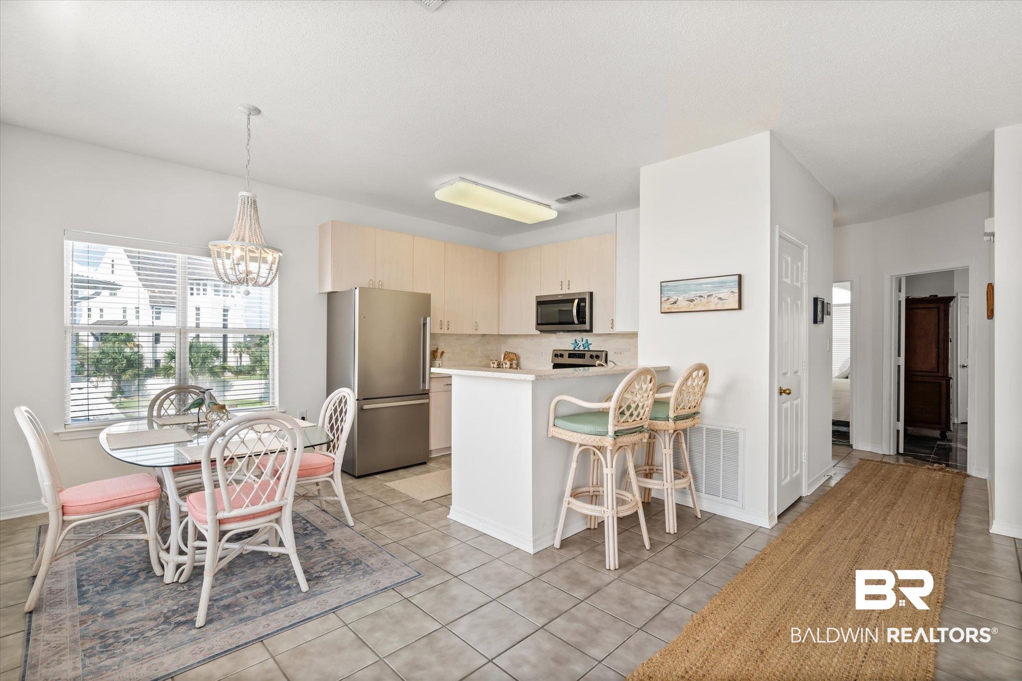 3575 Bayou Road, Unit A 10 Orange Beach, AL 36561 - Photo 9 of 31 Kitchen featuring light tile patterned flooring, kitchen peninsula, tasteful backsplash, a chandelier, and new appliances with stainless steel finishes