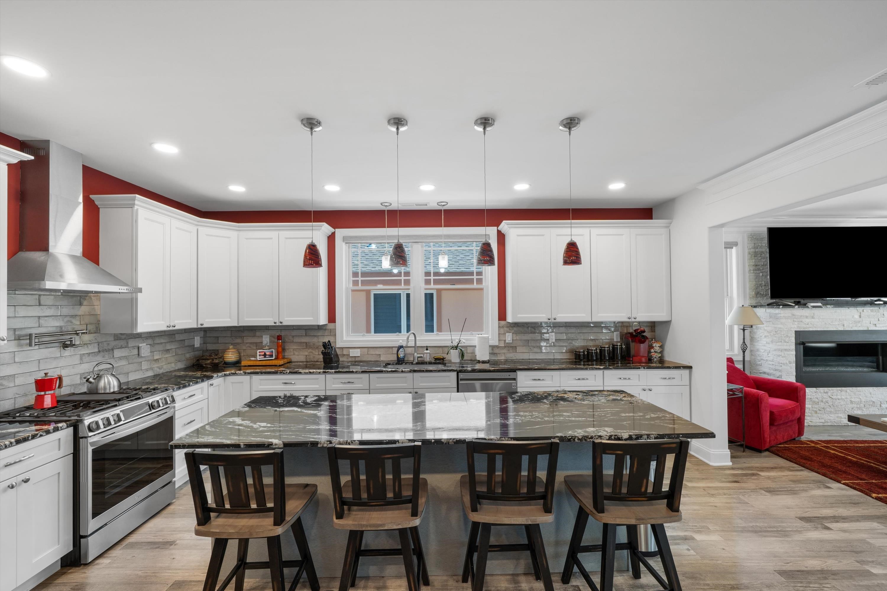305 East Stockton Road Wildwood Crest, NJ 08260 - Photo 13 of 28 a kitchen with granite countertop a dining table and chairs