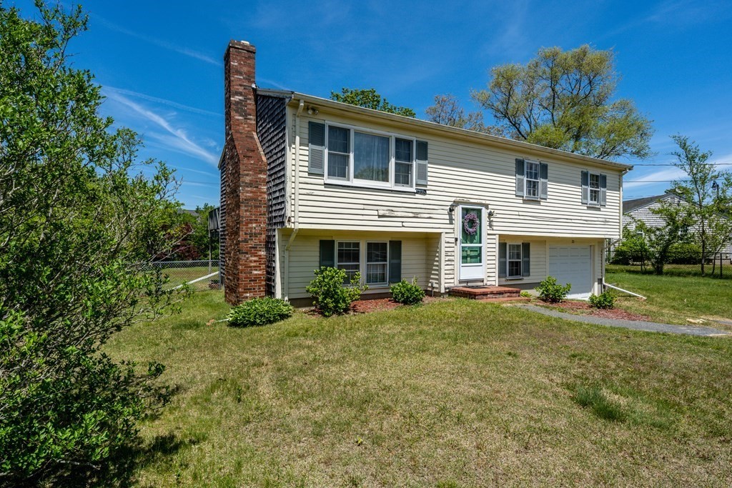 20 Alicia Road Barnstable, MA 02601 - Photo 3 of 24 a front view of a house with a yard and garage