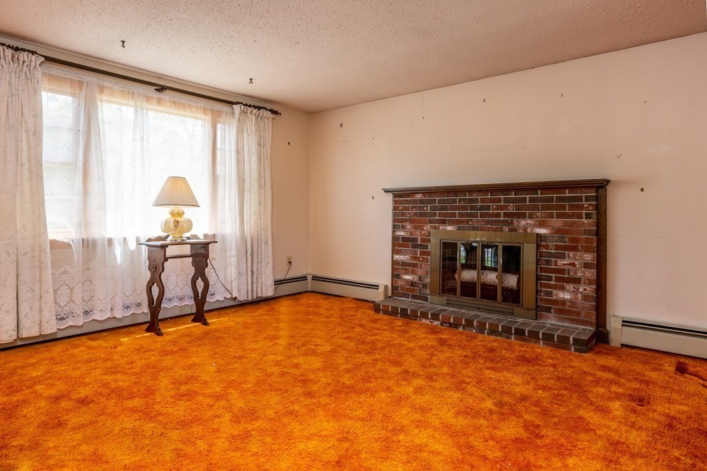 20 Alicia Road Barnstable, MA 02601 - Photo 6 of 24 a living room with furniture and a fireplace