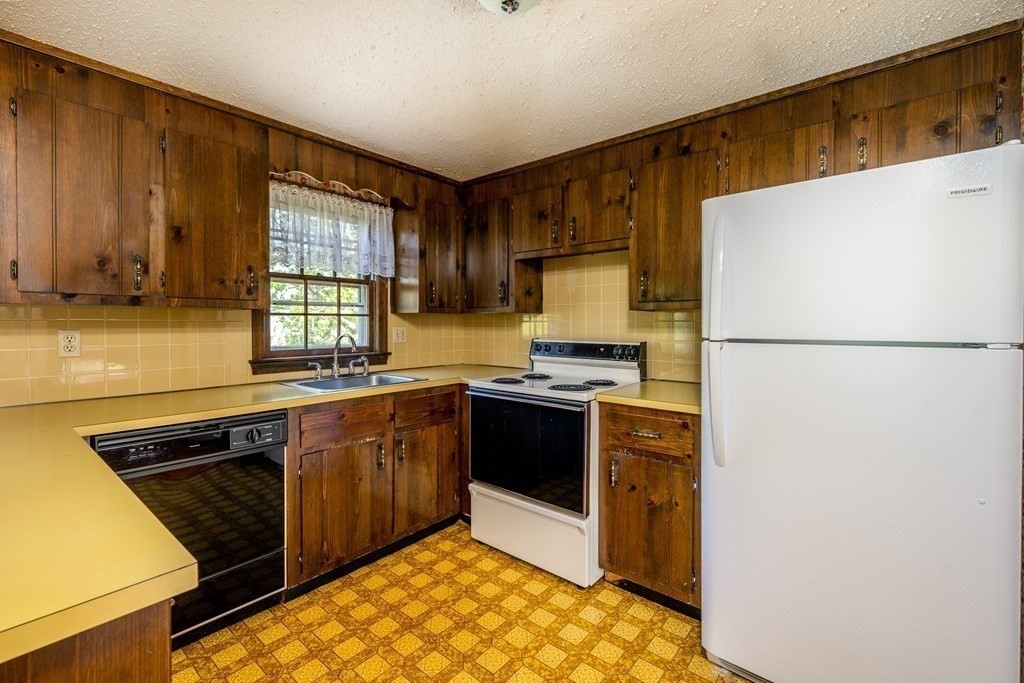 20 Alicia Road Barnstable, MA 02601 - Photo 7 of 24 a kitchen with a refrigerator and a sink