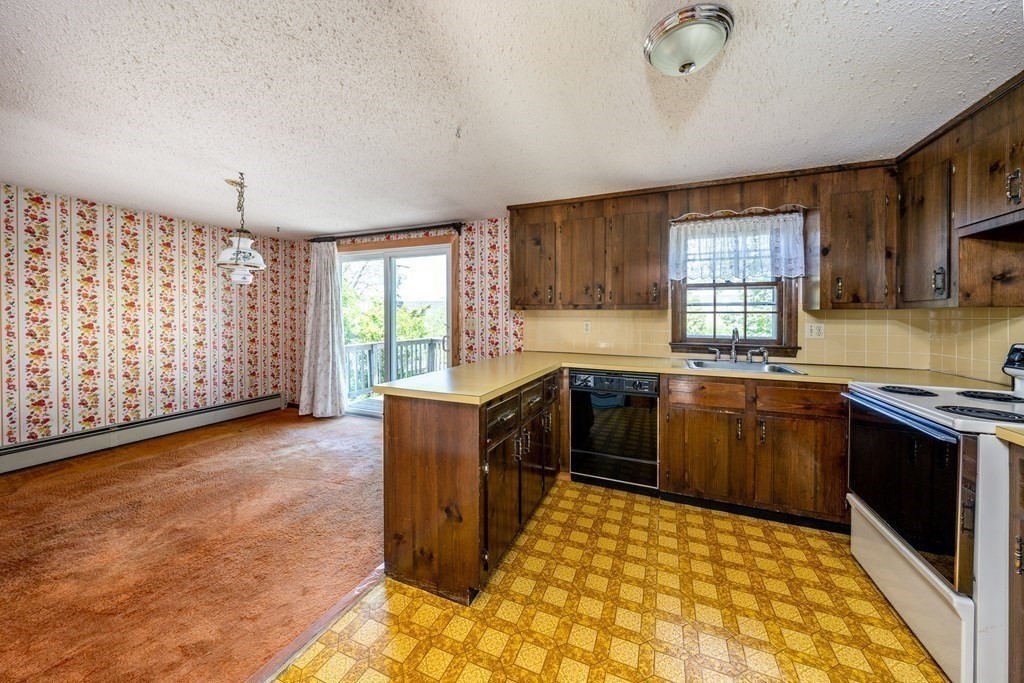 20 Alicia Road Barnstable, MA 02601 - Photo 8 of 24 a kitchen with stainless steel appliances granite countertop a stove a sink and a microwave