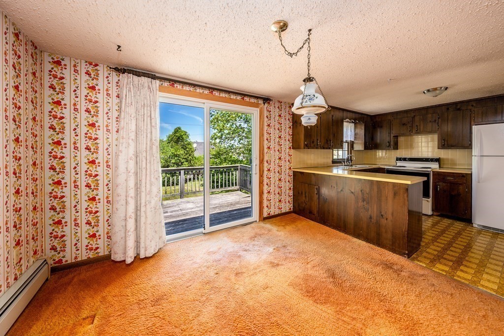 20 Alicia Road Barnstable, MA 02601 - Photo 9 of 24 a kitchen with stainless steel appliances granite countertop a sink a stove top oven a granite counter top and a view of living room