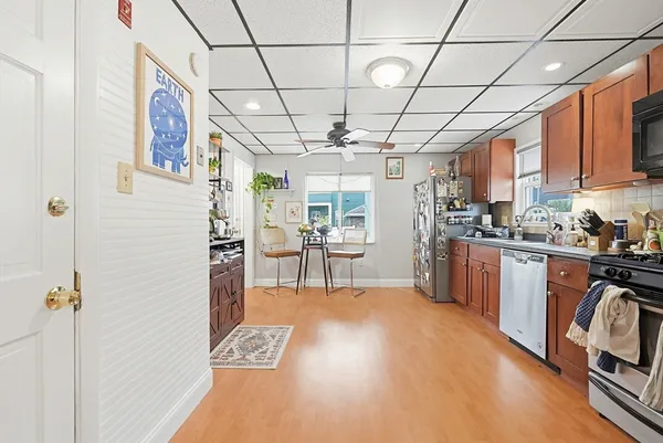 a kitchen with stainless steel appliances granite countertop a refrigerator and a stove top oven