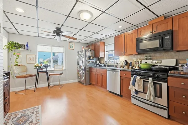 a kitchen with stainless steel appliances granite countertop a stove and a refrigerator