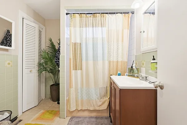 a bathroom with a sink a mirror and a shower
