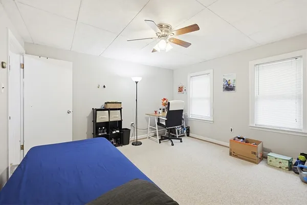 a bedroom with bed and a chandelier