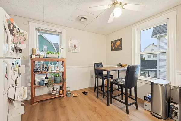 a view of a dining room with furniture and a window