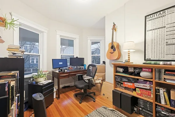 a view of a workspace with furniture and a window