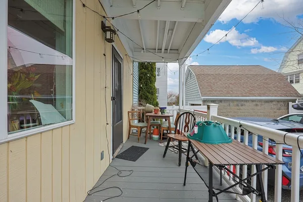 a balcony with table and chairs