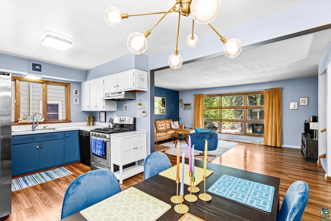 4119 Pitt Street Duluth, MN 55804 - Photo 31 of 50 Dining area featuring a dark-finish table and a modern sputnik chandelier