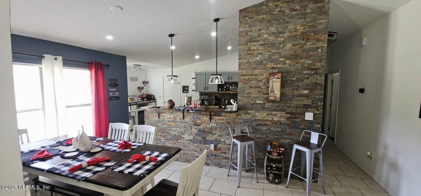 12961 5 Churches Road Sanderson, FL 32087 - Photo 11 of 34 a room with stainless steel appliances kitchen island granite countertop a stove and a chair