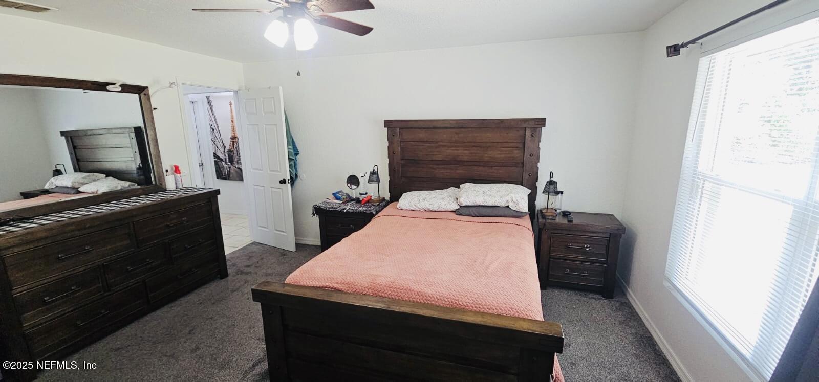 12961 5 Churches Road Sanderson, FL 32087 - Photo 18 of 34 a bedroom with a bed and a dresser