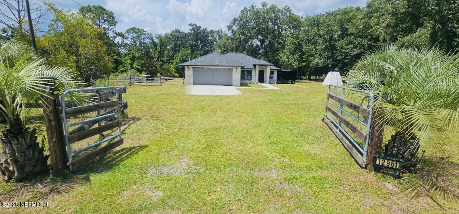 12961 5 Churches Road Sanderson, FL 32087 - Photo 2 of 34 a front view of a house with a yard