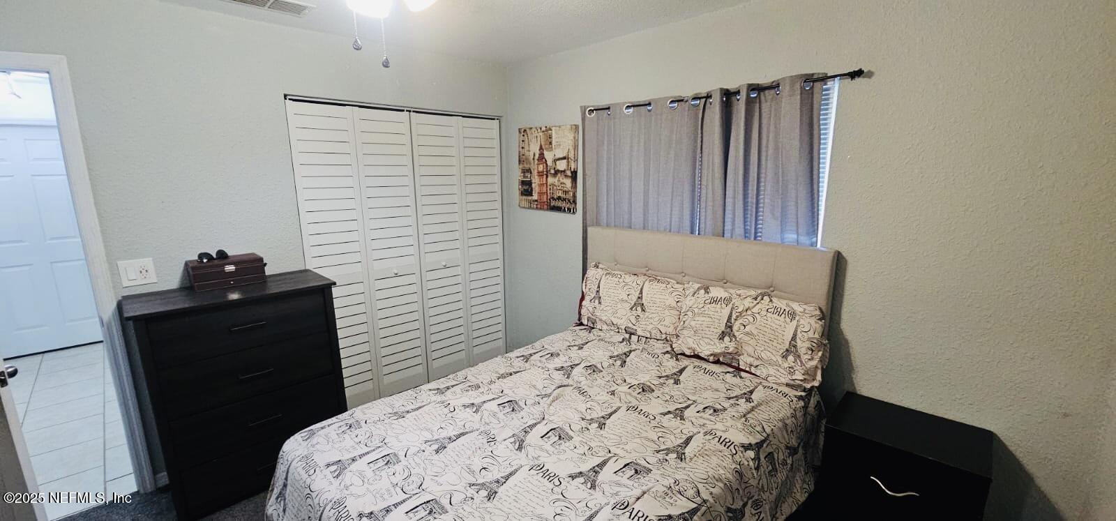 12961 5 Churches Road Sanderson, FL 32087 - Photo 21 of 34 a bedroom with a bed and a flat tv screen