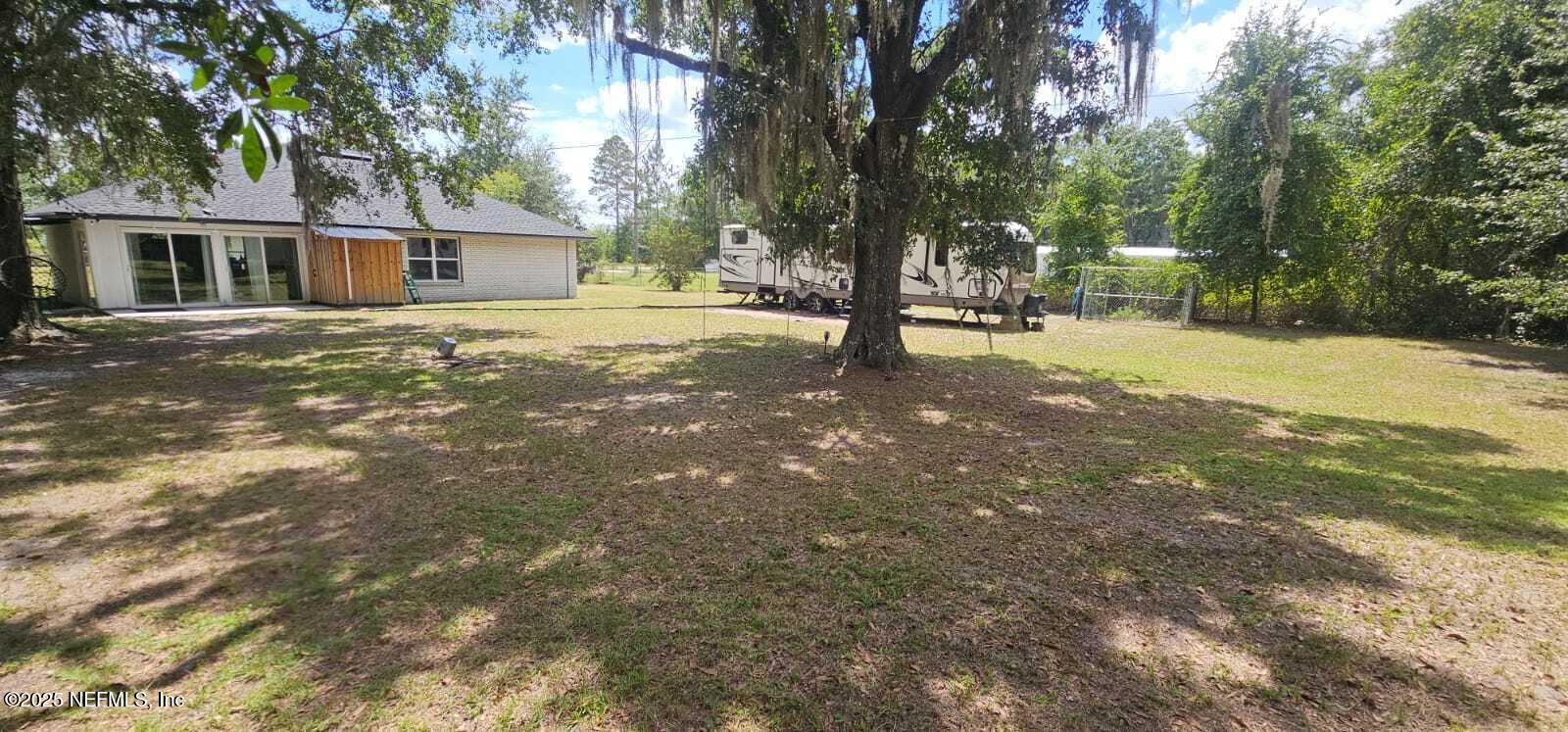 12961 5 Churches Road Sanderson, FL 32087 - Photo 31 of 34 a house with trees in front of it
