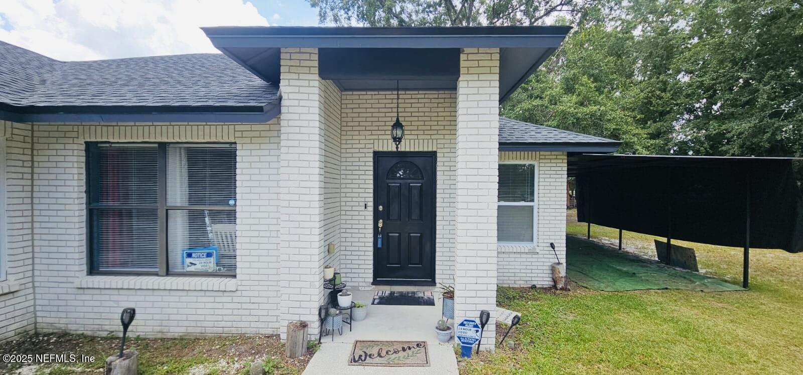 12961 5 Churches Road Sanderson, FL 32087 - Photo 6 of 34 a front view of a house with garden