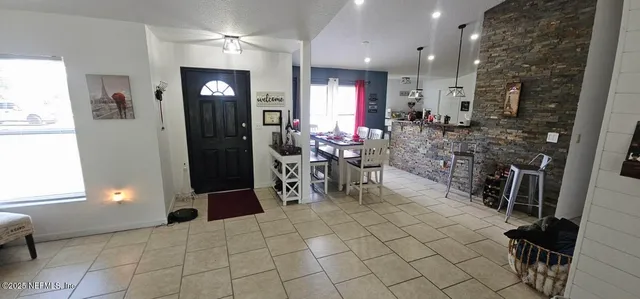 a room with lots of tables a mirror and a window