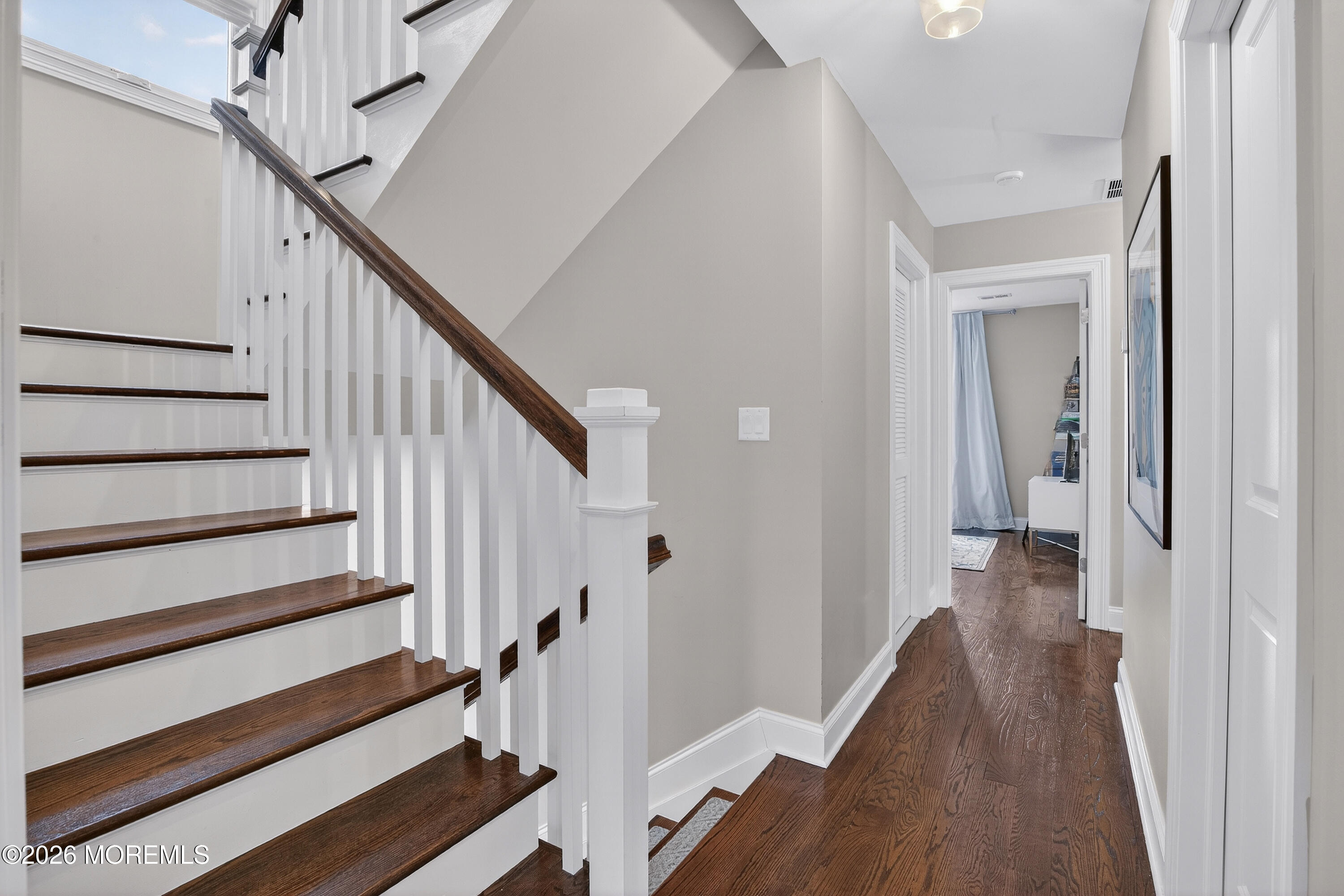 27 5th Street Highlands, NJ 07732 - Photo 16 of 62 a view of a hallway with wooden floor and staircase
