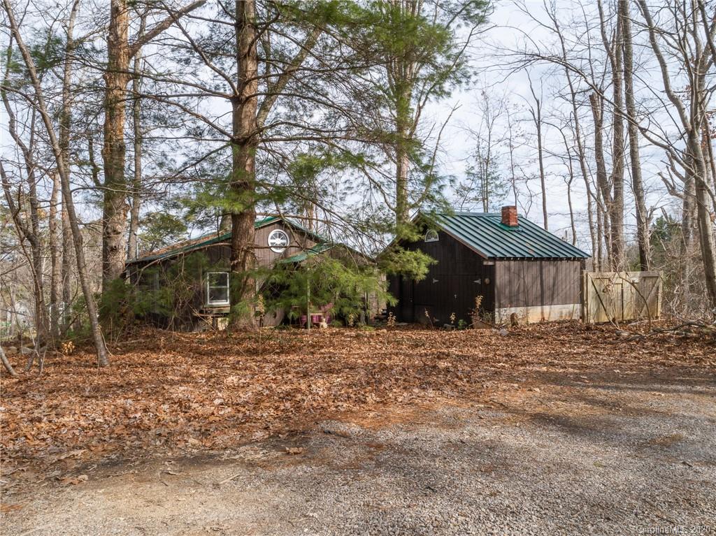 150 Oak Hill Road Candler, NC 28715 - Photo 11 of 25 a wooden house with trees in front of it