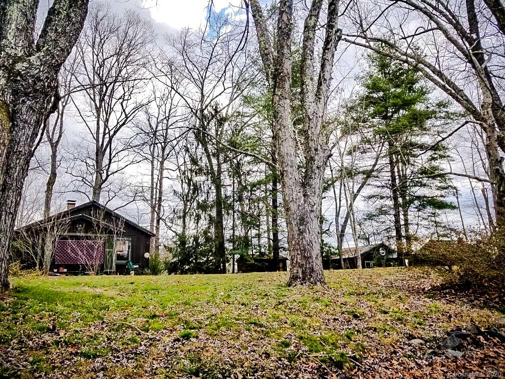 150 Oak Hill Road Candler, NC 28715 - Photo 17 of 25 a yellow house with trees in front of it