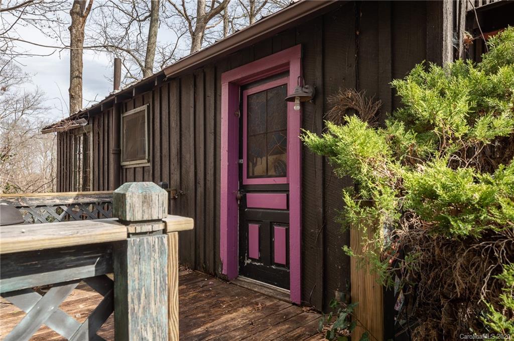 150 Oak Hill Road Candler, NC 28715 - Photo 10 of 25 a view of a house with potted plants and a tree
