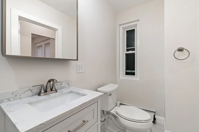 a white toilet sitting next to a bathroom sink