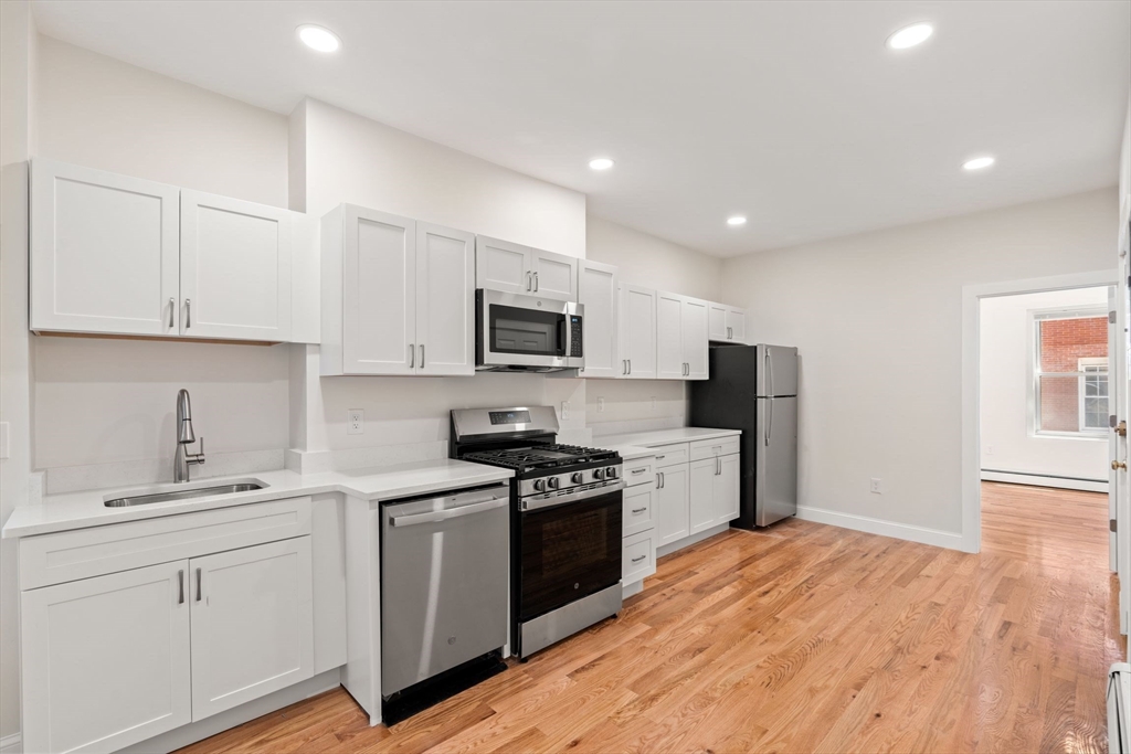 198 Salem Street, Unit 2 Boston, MA 02113 - Photo 2 of 21 a kitchen with granite countertop white cabinets and white appliances