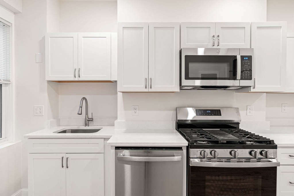 198 Salem Street, Unit 2 Boston, MA 02113 - Photo 4 of 21 a kitchen with granite countertop a stove and a sink
