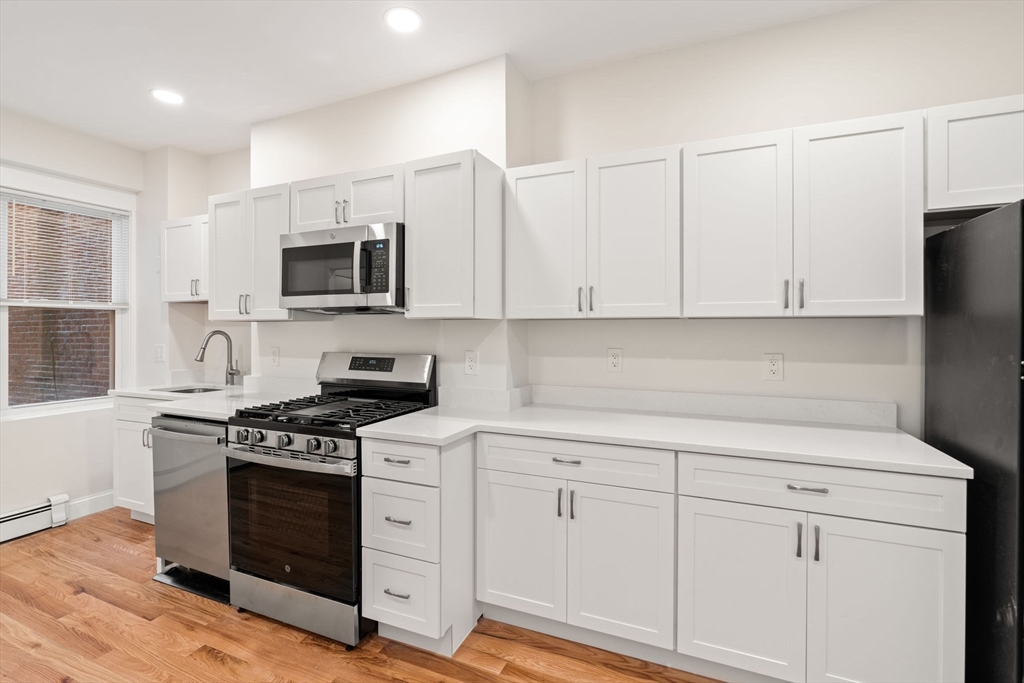198 Salem Street, Unit 2 Boston, MA 02113 - Photo 5 of 21 a kitchen with white cabinets and appliances