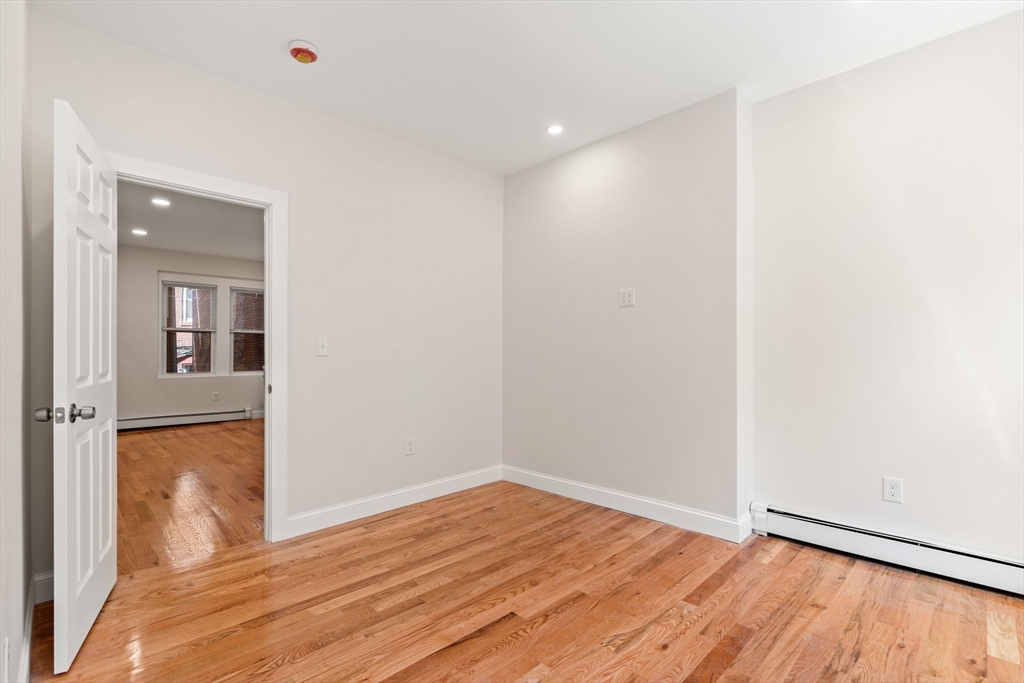 198 Salem Street, Unit 2 Boston, MA 02113 - Photo 7 of 21 a view of empty room with wooden floor