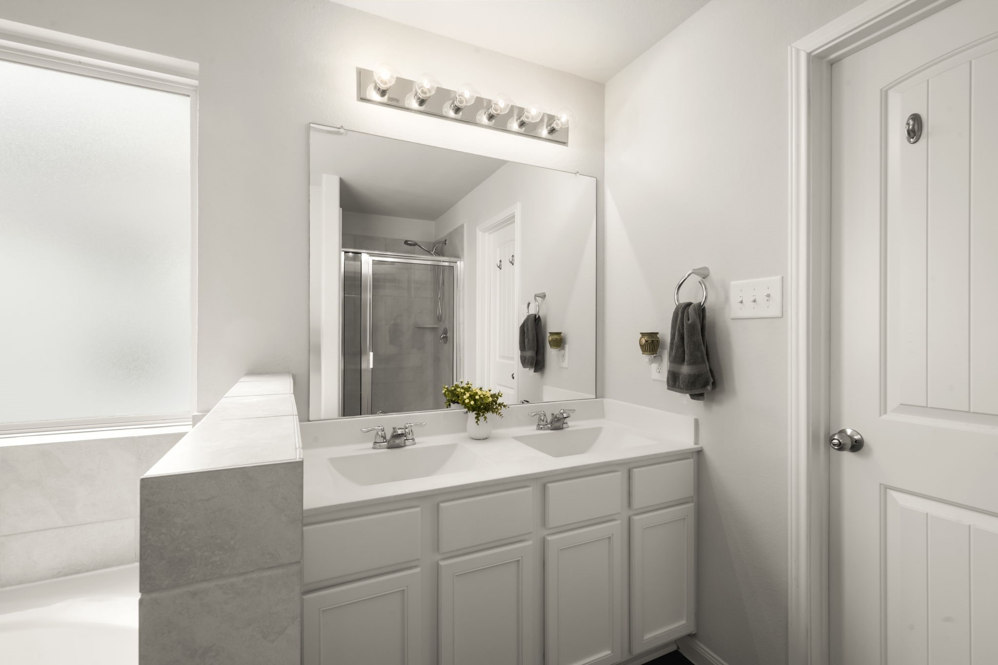 4915 Blue Jacaranda Way Spring, TX 77373 - Photo 17 of 30 Primary bath provides a clean, modern design with a double vanity, large mirror, separate shower and tub.