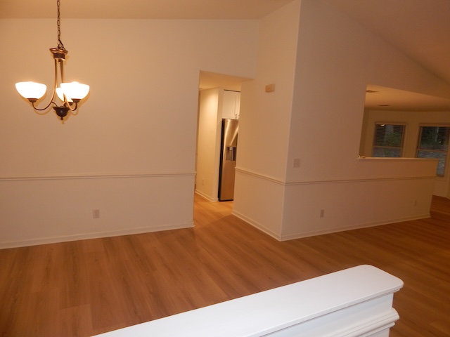 620 Downs Loop Clemson, SC 29631 - Photo 4 of 35 Gleaming wood-look floors complement the vaulted ceiling and classical wainscoting details.